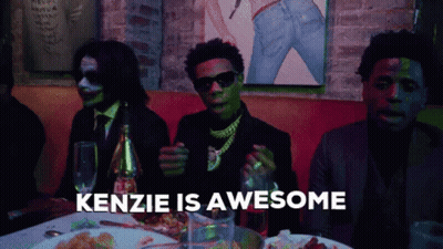 Group Of Men Sitting At Table Saying Kenzie Is Awesome GIF