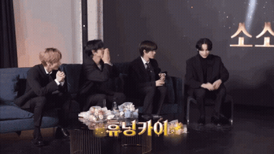 Group Of Men Sitting On Couch With Foreign Language Table GIF