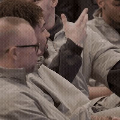 Group Of Men Sitting One Raising Hand GIF