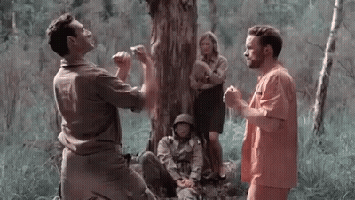 Group of Men Sitting Under Tree in Forest