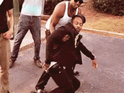 Group Of Men Standing Around Man On Ground GIF