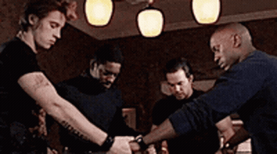 Group Of Men Standing Around Table GIF