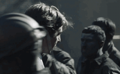 Group Of Men Standing In Dark Room Talking GIF