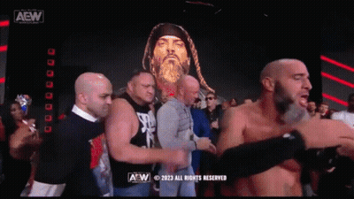 Group Of Men Standing In Front Of AEW Screen GIF