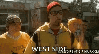 Group Of Men Standing In Front Of Building One Wearing Glasses And Red Hat GIF