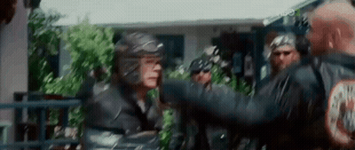 Group Of Men Standing In Front Of Building One Wearing Helmet GIF