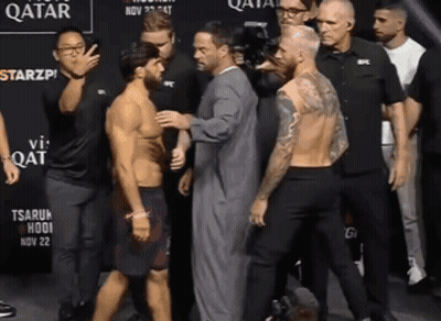 Group Of Men Standing In Front Of Qatar Sign GIF