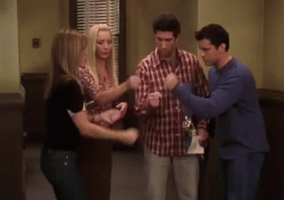 Group Of Men Standing In Room One In Blue Sweater GIF