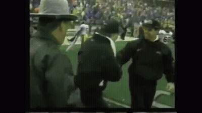 Group Of Men Standing On Football Field GIF