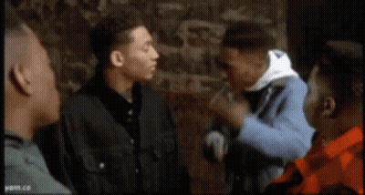 Group Of Men Talking In Front Of Stone Wall GIF
