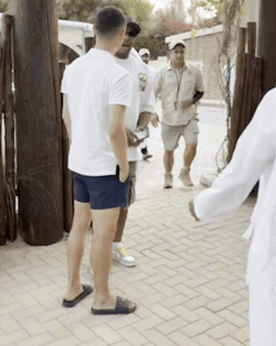 Group Of Men Talking On Brick Sidewalk GIF