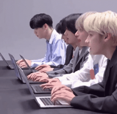 Group Of Men Typing On Laptops At Table GIF