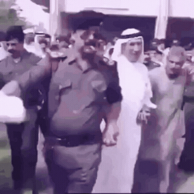 Group Of Men Walking Down Street GIF