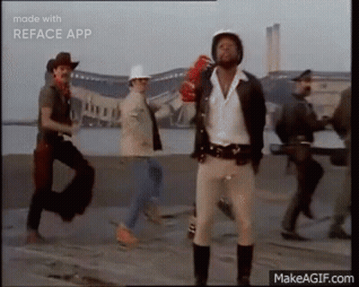 Group Of Men Walking Down Street One Wearing Helmet GIF
