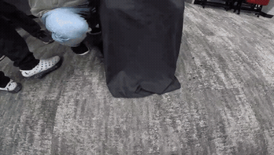 Group Of People Around Black Bag GIF