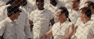 Group Of People Behind Chain Link Fence GIF