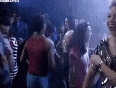 Group Of People Dancing At Party In Dark Room GIF