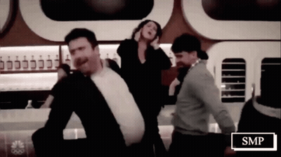 Group Of People Dancing Beside SMP Sign GIF