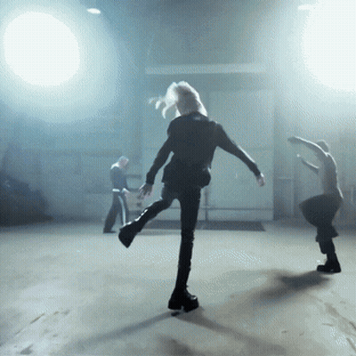 Group Of People Dancing In Dark Room With Spotlight GIF