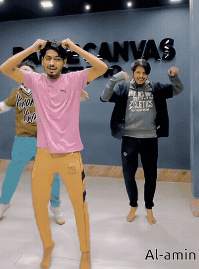 Group of People Dancing in Front of Canvas Wall
