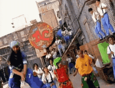 Group Of People Dancing In Front Of Pizza Place GIF