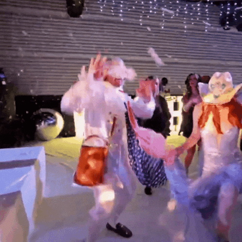 Group Of People Dancing In Front Of Sign Saying B GIF