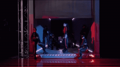 Group Of People Dancing In Red-Lit Dark Room GIF
