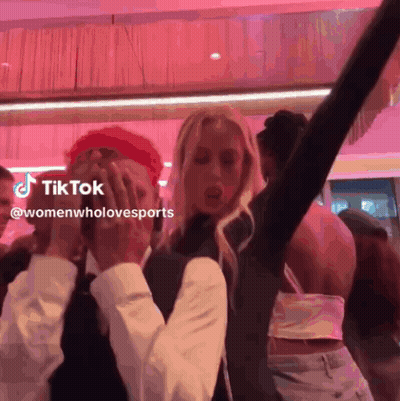Group Of People Dancing On Pink Background With TikTok Logo GIF