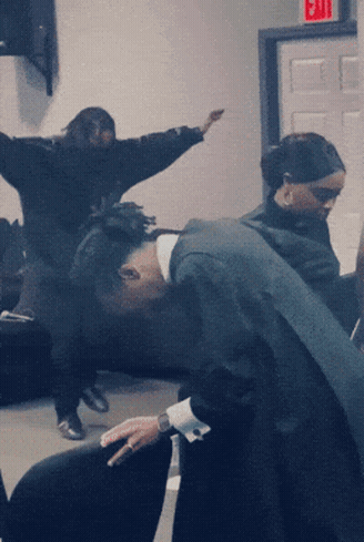 Group Of People Dancing Under Red Exit Sign GIF