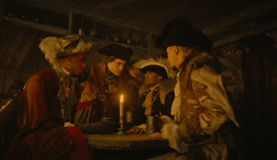 Group Of People Gathered Around Table With Candle GIF