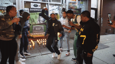 Group Of People Gathered In Front Of Rip Sign GIF