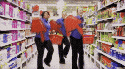 Group Of People Holding Baskets In Store GIF