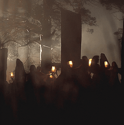 Group of People Holding Candles in Dark