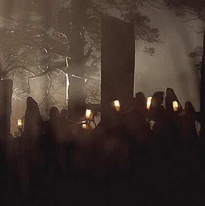 Group Of People Holding Candles In Forest GIF