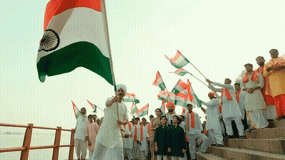 Group of People Holding Indian Flags on Shore