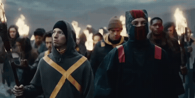 Group Of People Holding Torches Walking In Line GIF