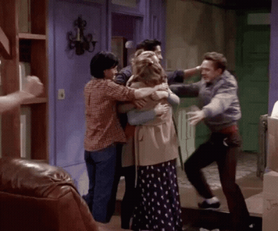 Group Of People Hugging In Living Room GIF