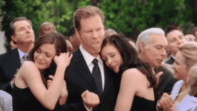 Group Of People Hugging Man In Suit GIF