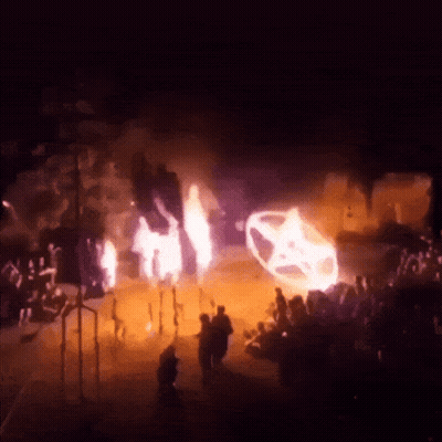 Group Of People In Dark Room With Burning Car GIF