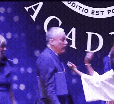 Group Of People In Front Of Acad Sign GIF