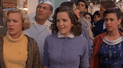 Group Of People In Front Of Back To The Future Sign GIF