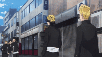 Group Of People In Front Of Building With Sign A GIF