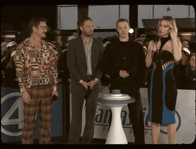 Group Of People In Front Of Sign Saying 4 GIF