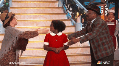 Group Of People In Front Of Stairs With NBC Logo GIF