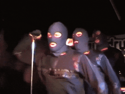 Group Of People In Ski Masks At Microphone GIF