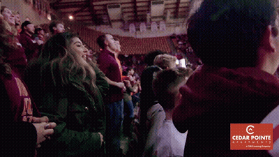 Group Of People In Stadium With Cedar Pointe Advertisement GIF