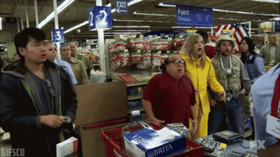 Group Of People In Store With Exit Sign GIF