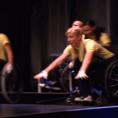 Group Of People In Wheelchairs Raising Hands GIF