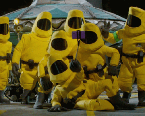 Group Of People In Yellow Suits Taking Picture GIF
