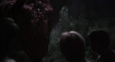 Group Of People Looking At Large Red Monster In Dark GIF